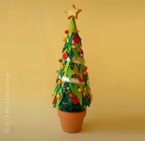 Christmas-tree-in-pot-festooned-with-star-on-top-home-decoration                                                  